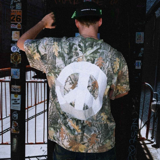Back view of DG Gamble x Comfortable Silence one-of-one camouflage t-shirt featuring hand-sewn patchwork peace sign
