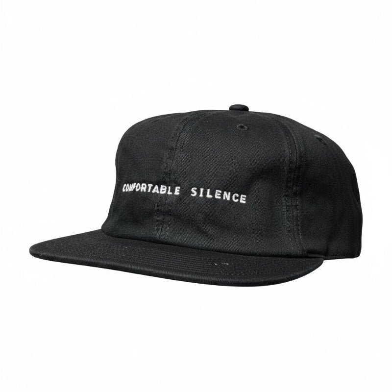 Black cap with 'Comfortable Silence' text on a white background