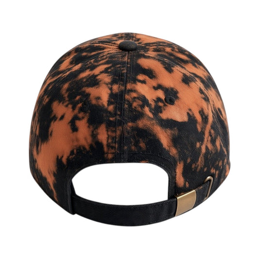 A baseball cap viewed from the back, featuring a black and orange mottled tie-dye pattern with a black adjustable strap and a small gold metal accent.