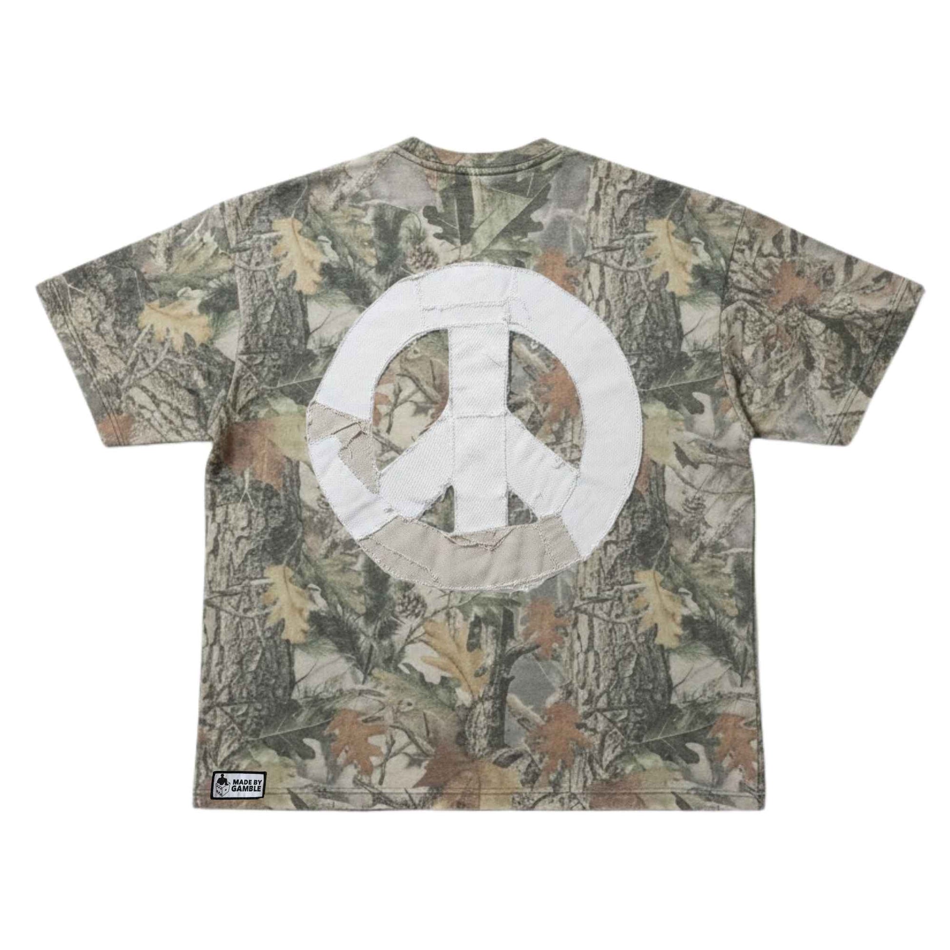 DG Gamble x Comfortable Silence one-of-one camouflage t-shirt with hand-sewn denim patchwork peace sign on back on a white background