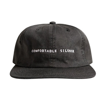 Black cap with 'Comfortable Silence' text on a white background
