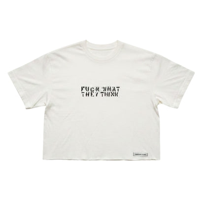 An off-white cropped t-shirt with the text 'FUCK WHAT THEY THINK' printed in black across the chest, displayed flat against a white background.