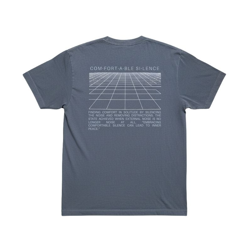 Back view of the faded indigo t-shirt featuring a large white perspective grid graphic and a paragraph about finding comfort in solitude, on a white background.